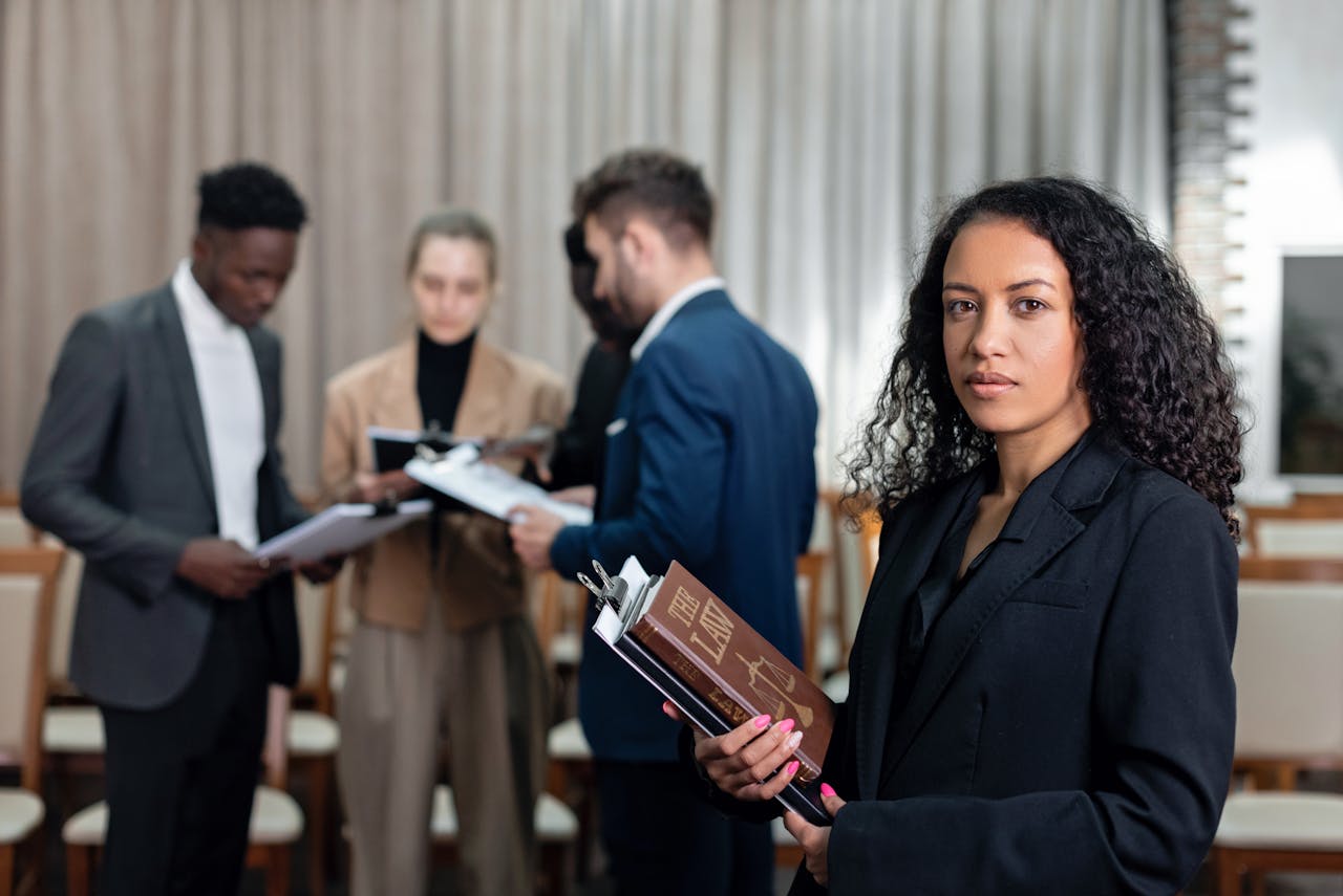 A diverse group of professionals in a corporate office setting engaged in important discussions.